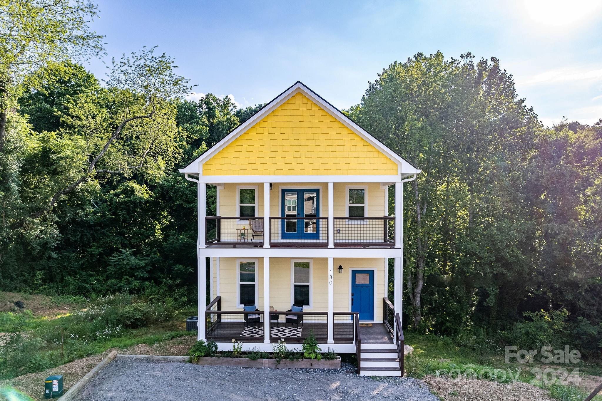 a view of a house with yard and sitting area