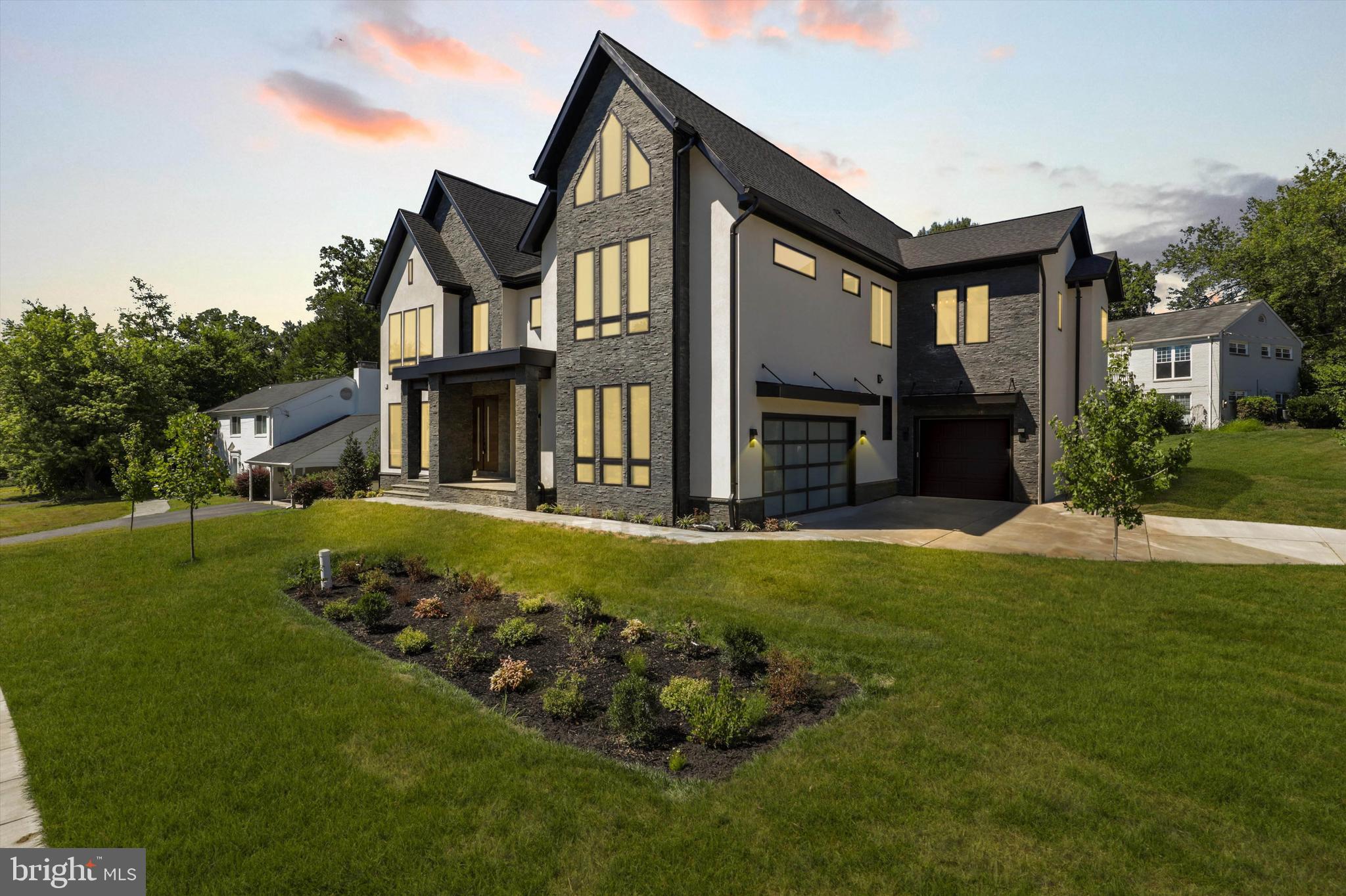 a front view of a house with a garden