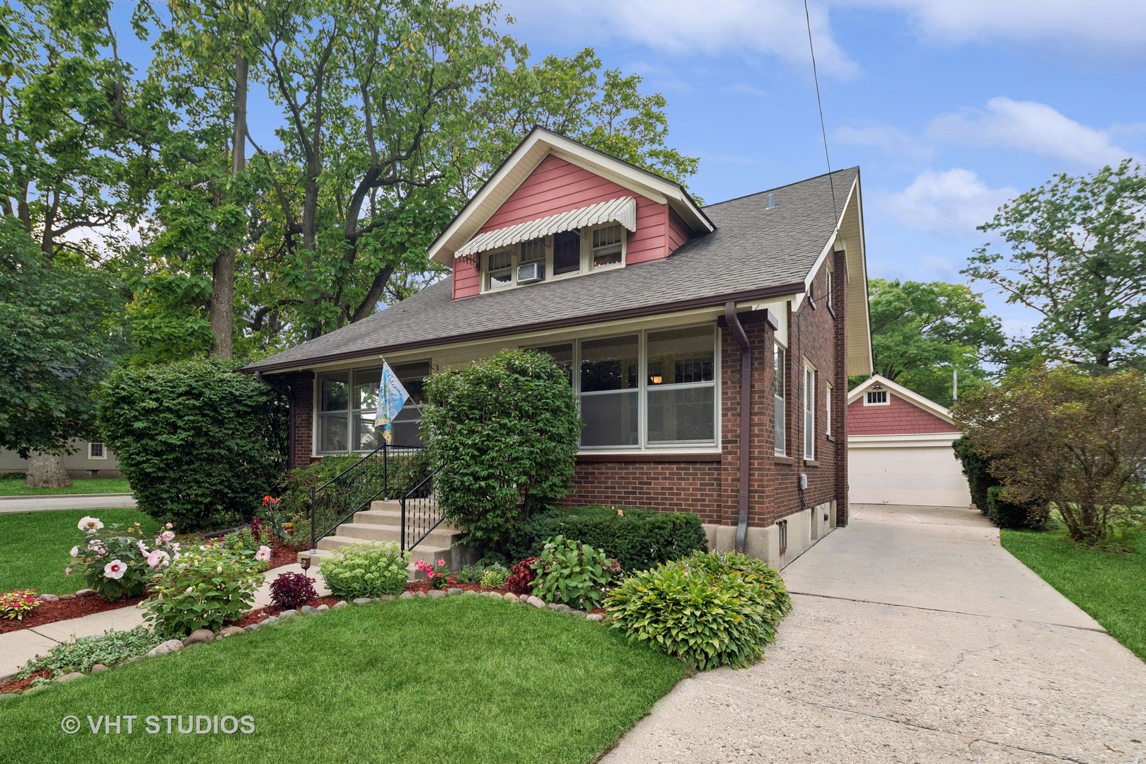 a front view of house with yard and green space