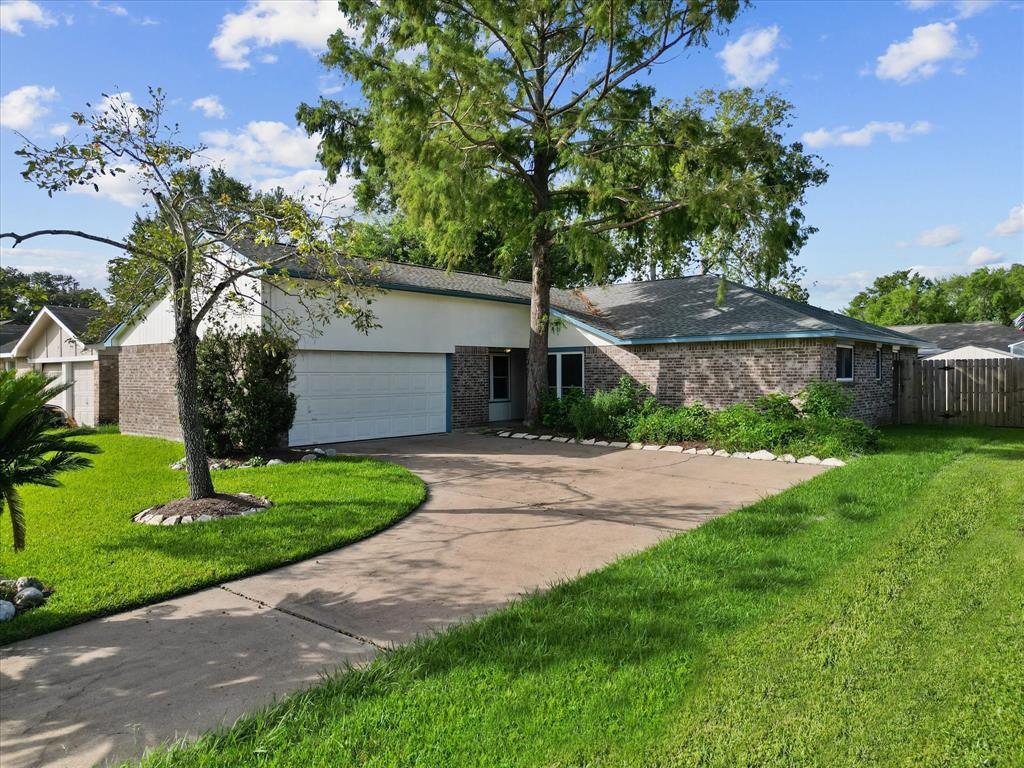 a front view of a house with a yard and a garage