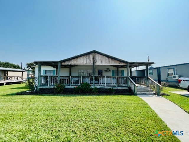 a view of a house with a yard and sitting area