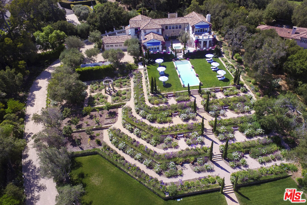 an aerial view of residential houses with outdoor space and swimming pool