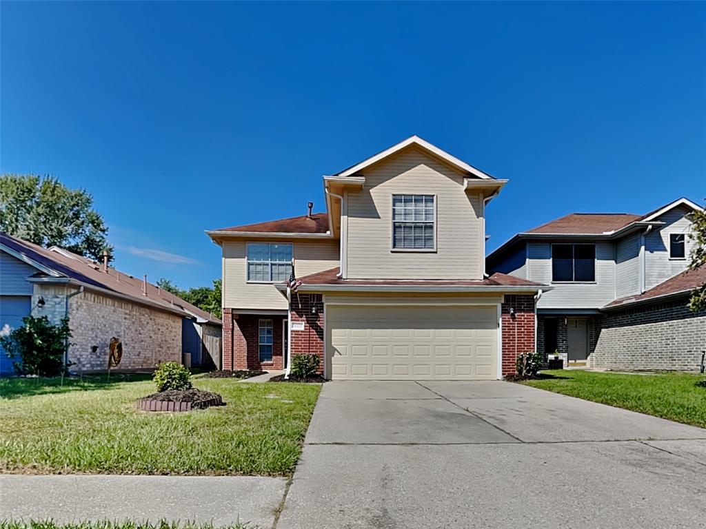 a front view of a house with a yard and garage