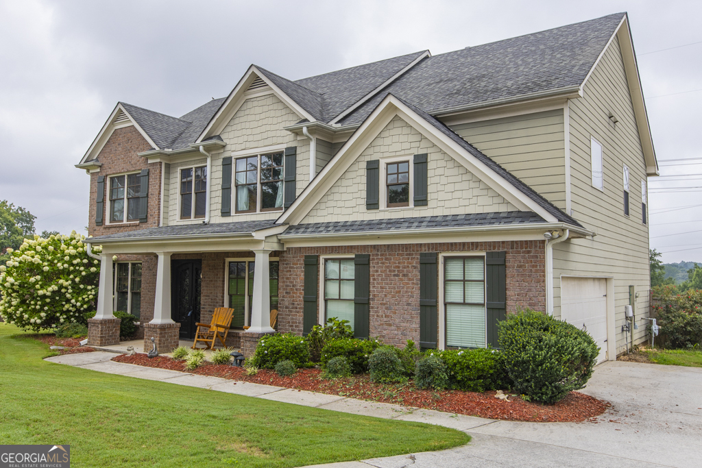 a front view of a house with a yard and porch