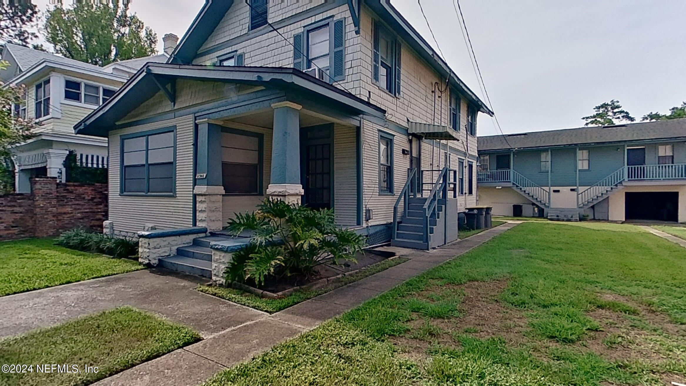 a front view of a house with a garden and plants