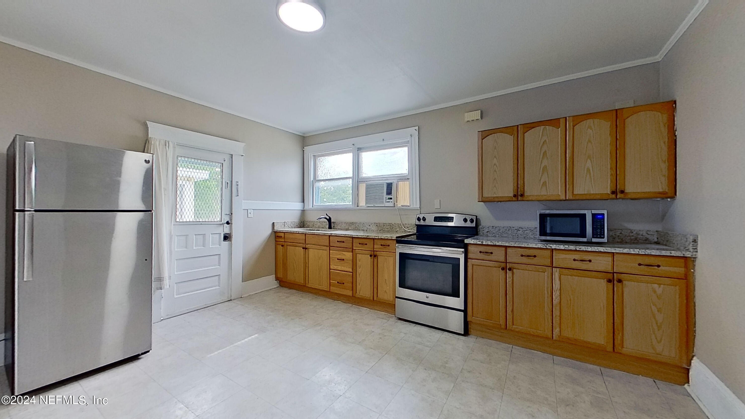 a kitchen with stainless steel appliances granite countertop a refrigerator sink and cabinets