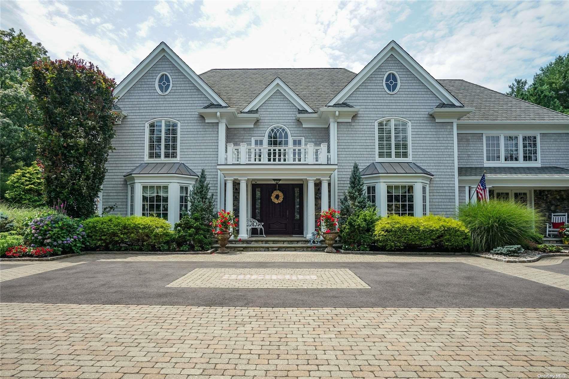 a front view of a house with a yard and a garage