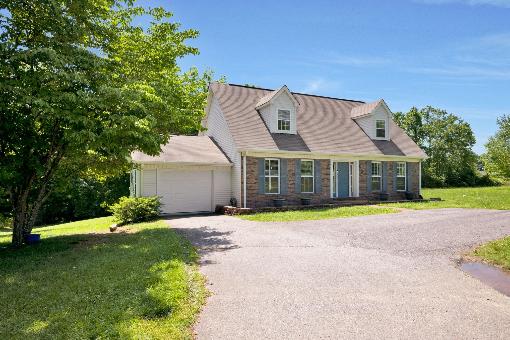 a front view of house with yard and green space