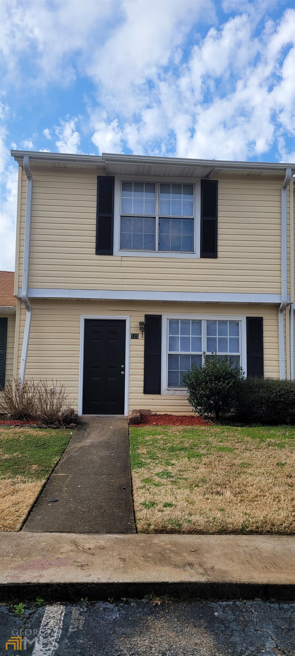 a front view of a house with a yard