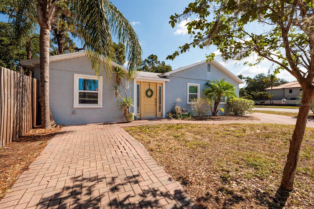 a view of a house with a tree in front