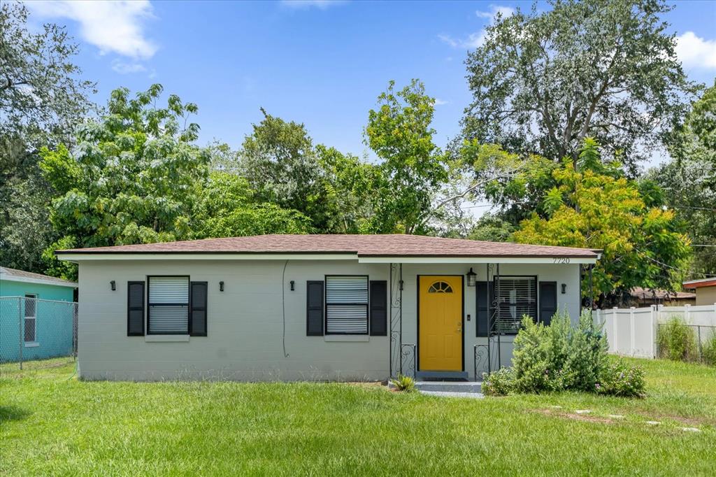 a view of a house with a yard and plants