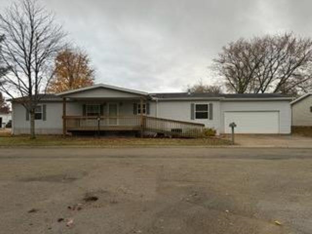 a front view of house with yard and trees around