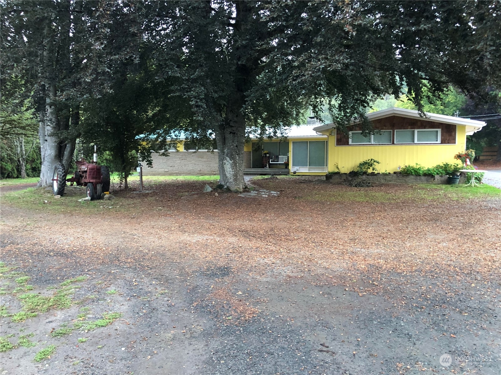 a view of a house with a yard and sitting area