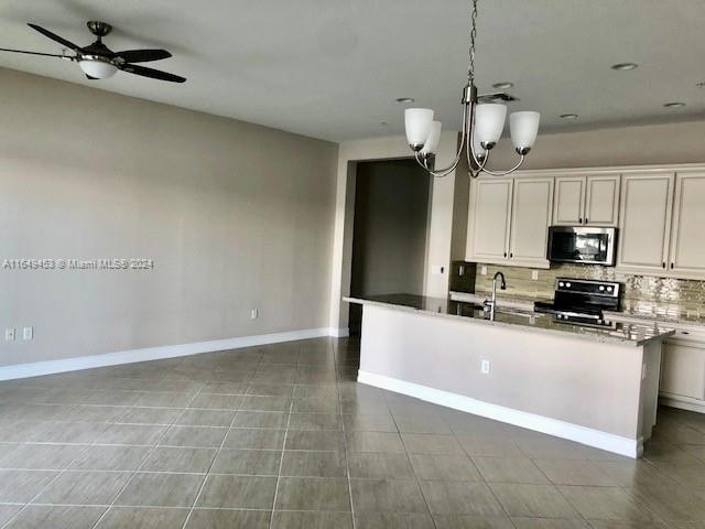 a large kitchen with cabinets a sink and stainless steel appliances