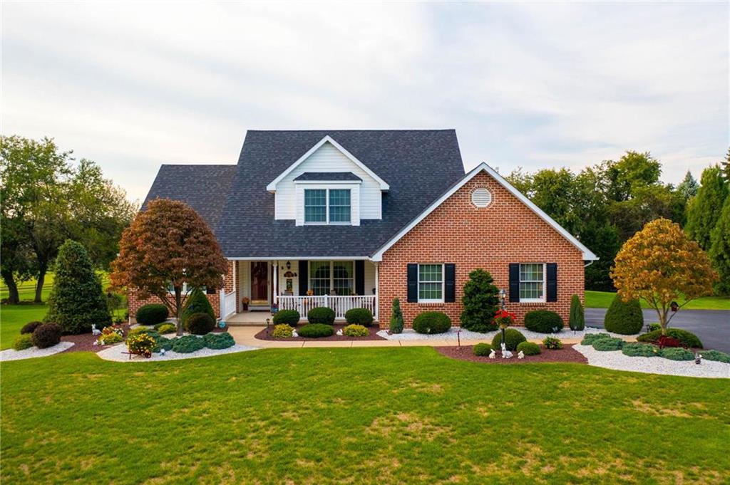 a front view of house with yard and green space