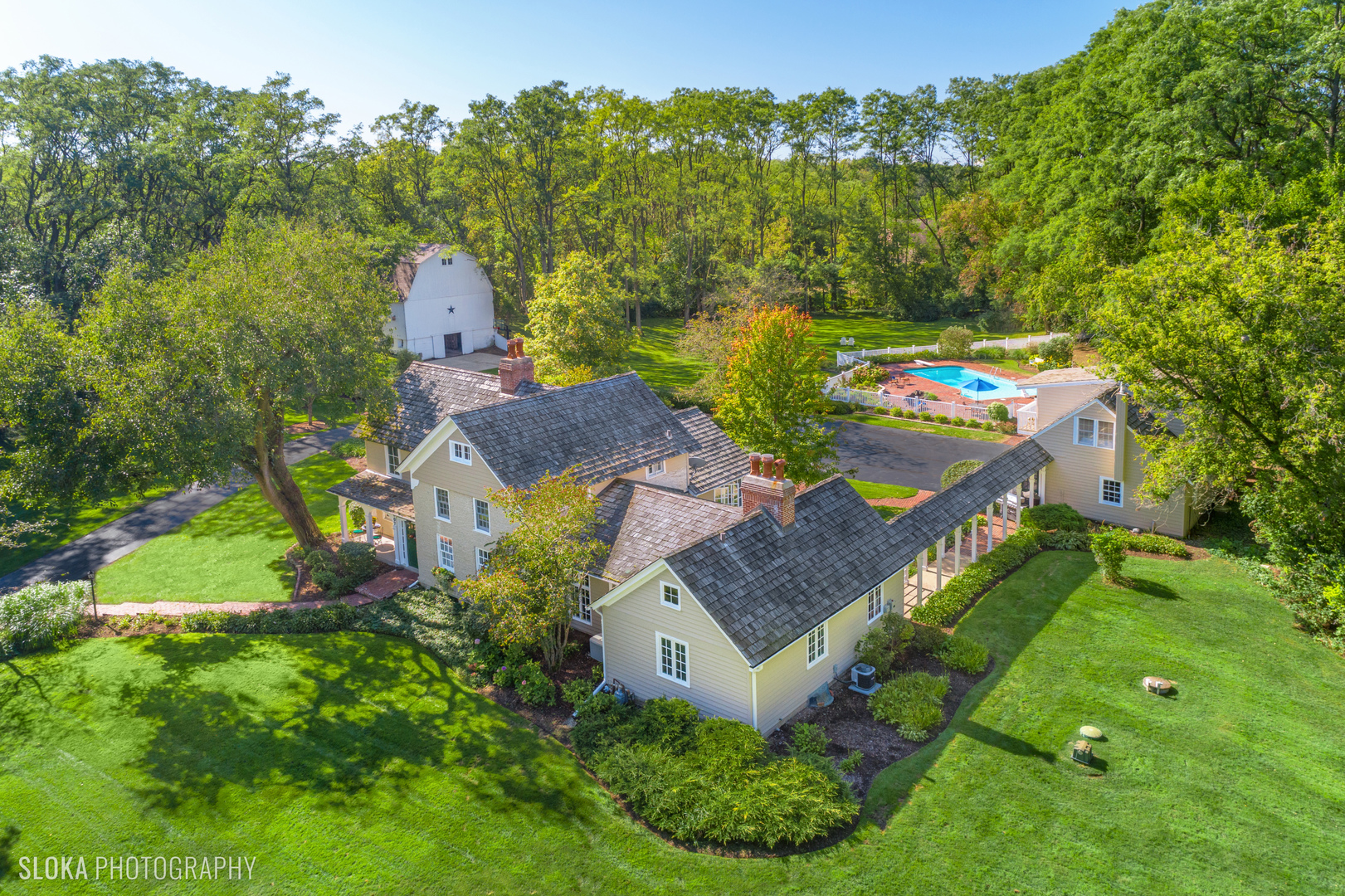 an aerial view of a house with yard swimming pool and outdoor seating