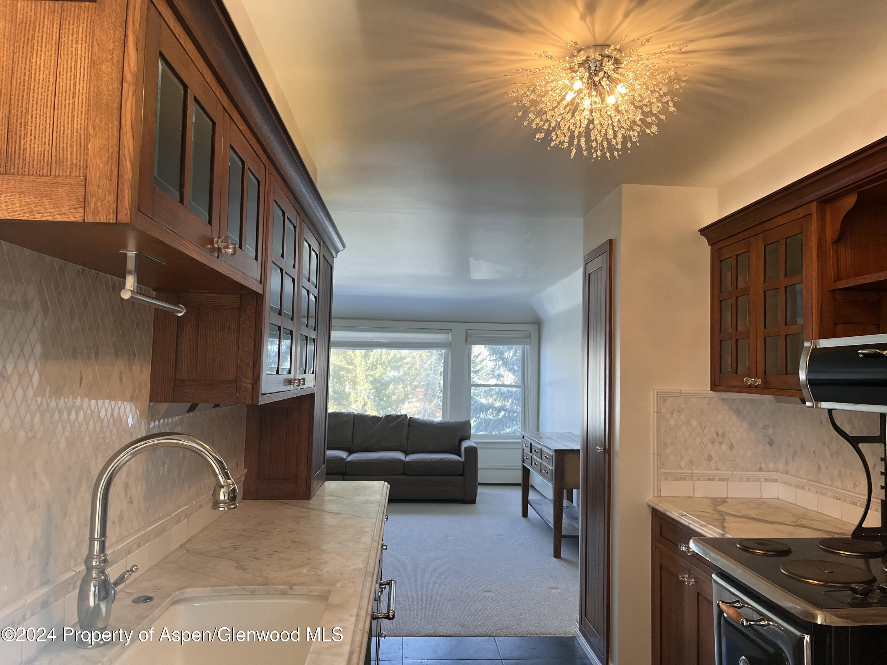 a kitchen with a sink stainless steel appliances and cabinets