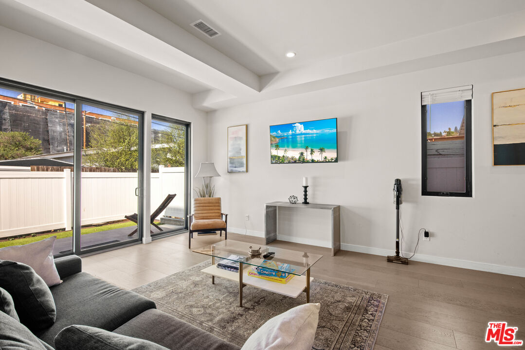 a living room with furniture and a floor to ceiling window