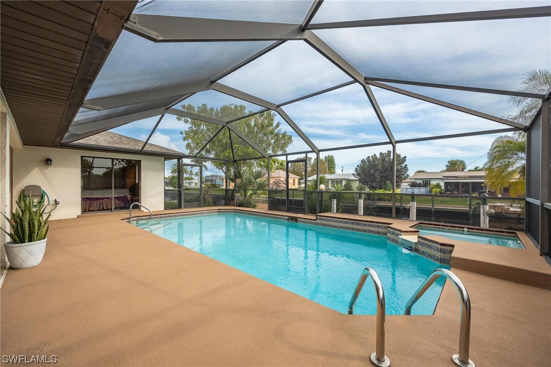 a view of a swimming pool with a patio and a yard