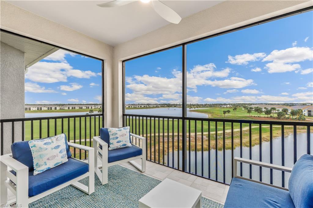 a living room with furniture tv and a floor to ceiling window