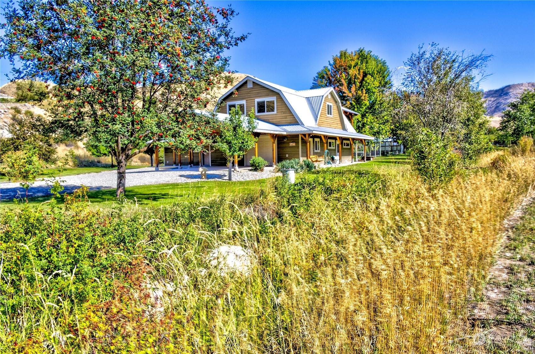 a front view of a house with a yard and fountain