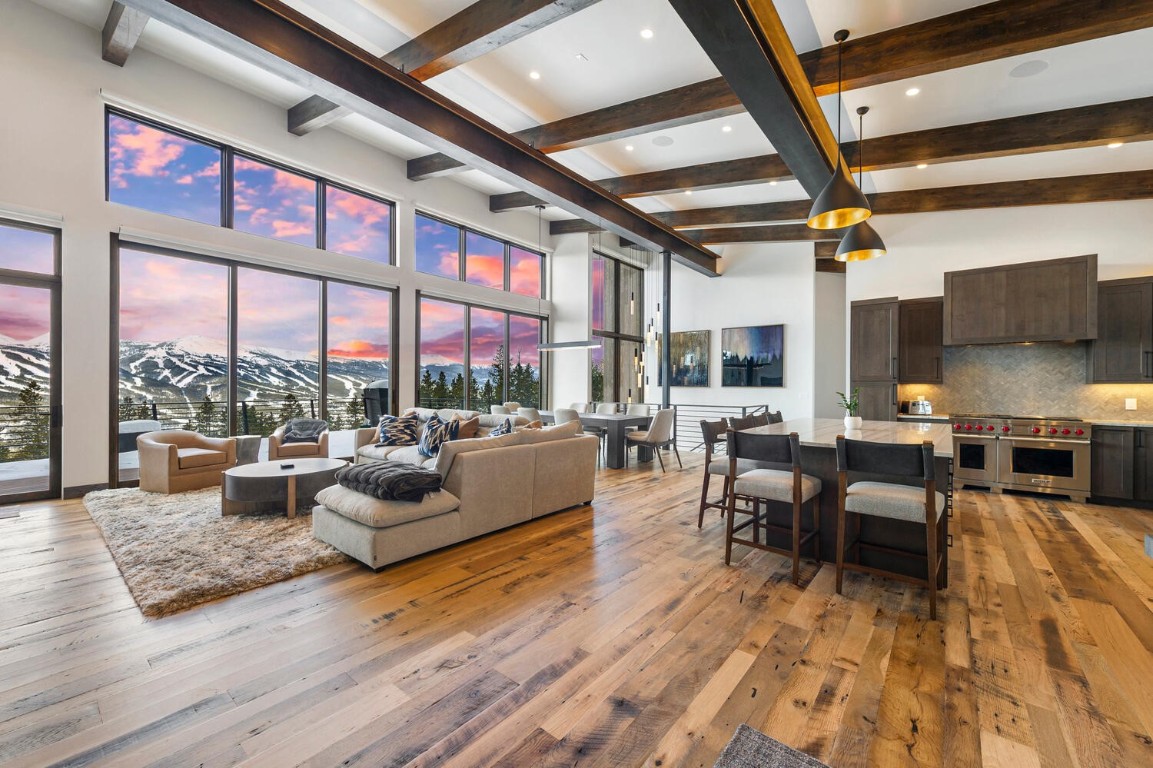 a living room with fireplace furniture and a large window