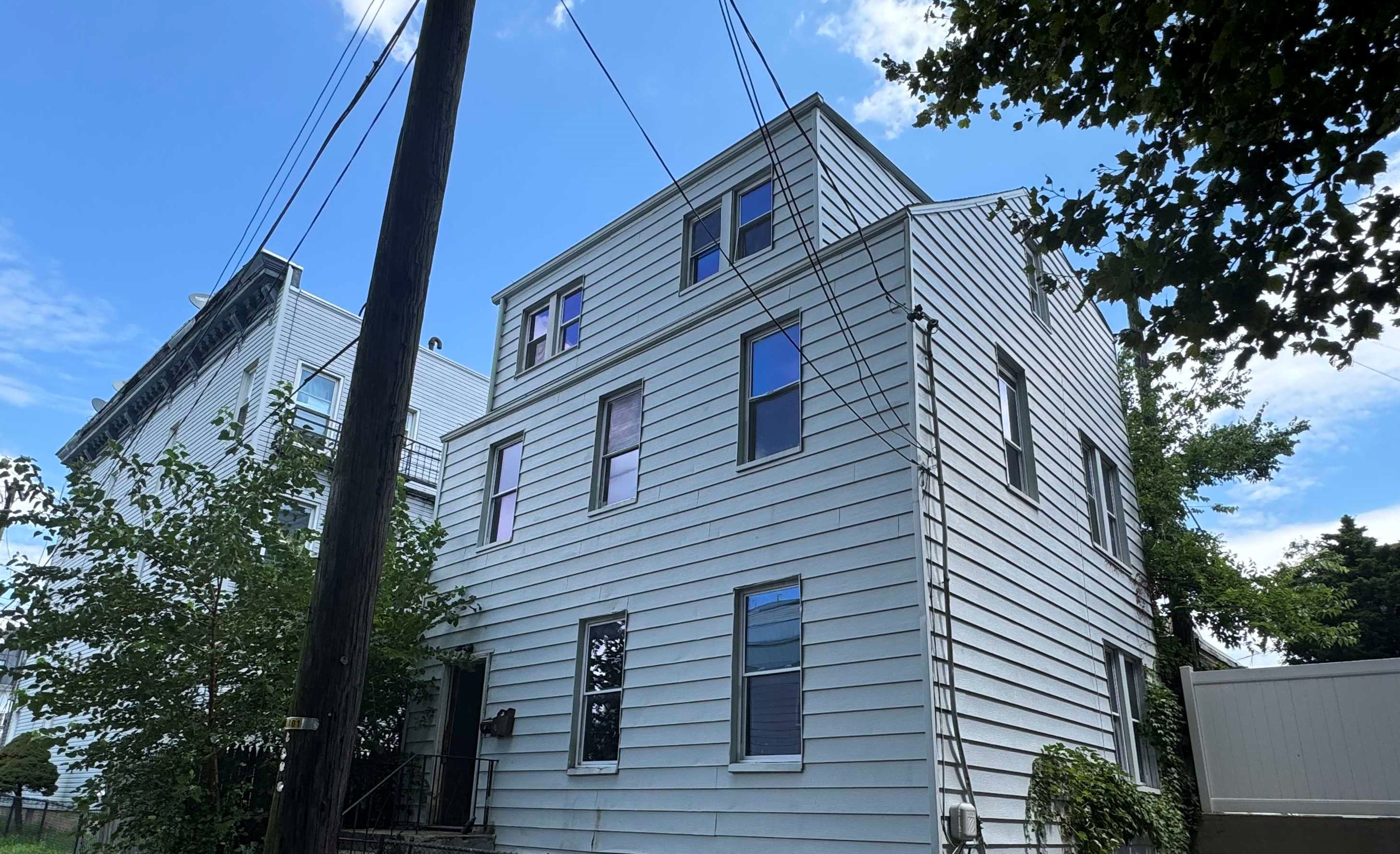 a front view of a house with a tree