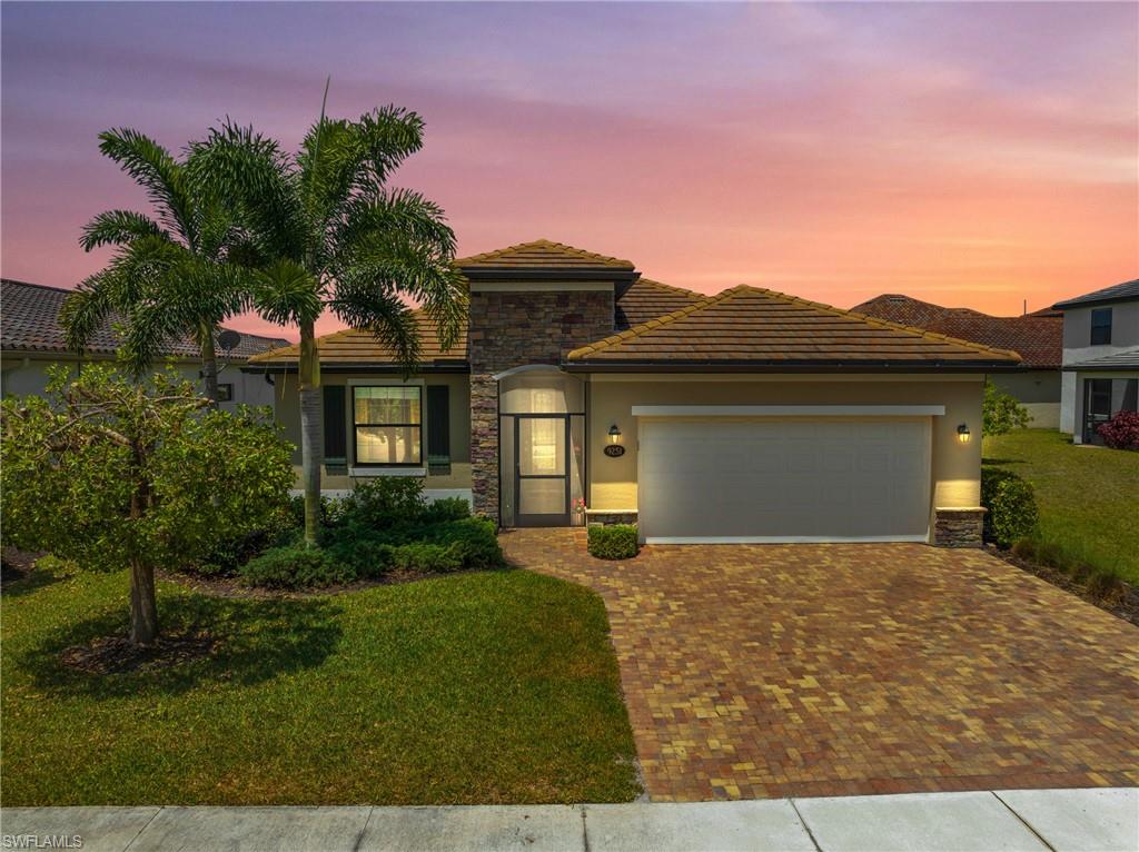 a front view of a house with a yard and garage