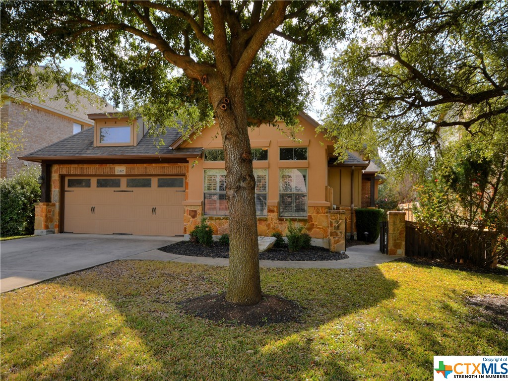 a front view of house with yard and trees in the background