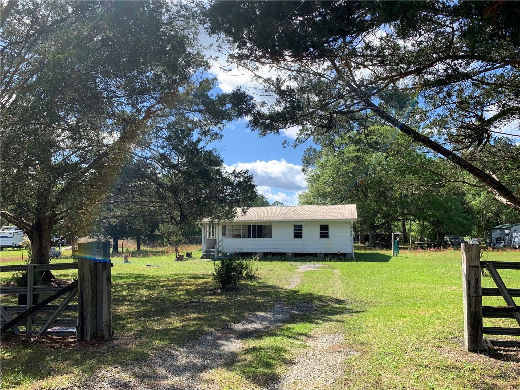 a view of a house with yard and sitting area