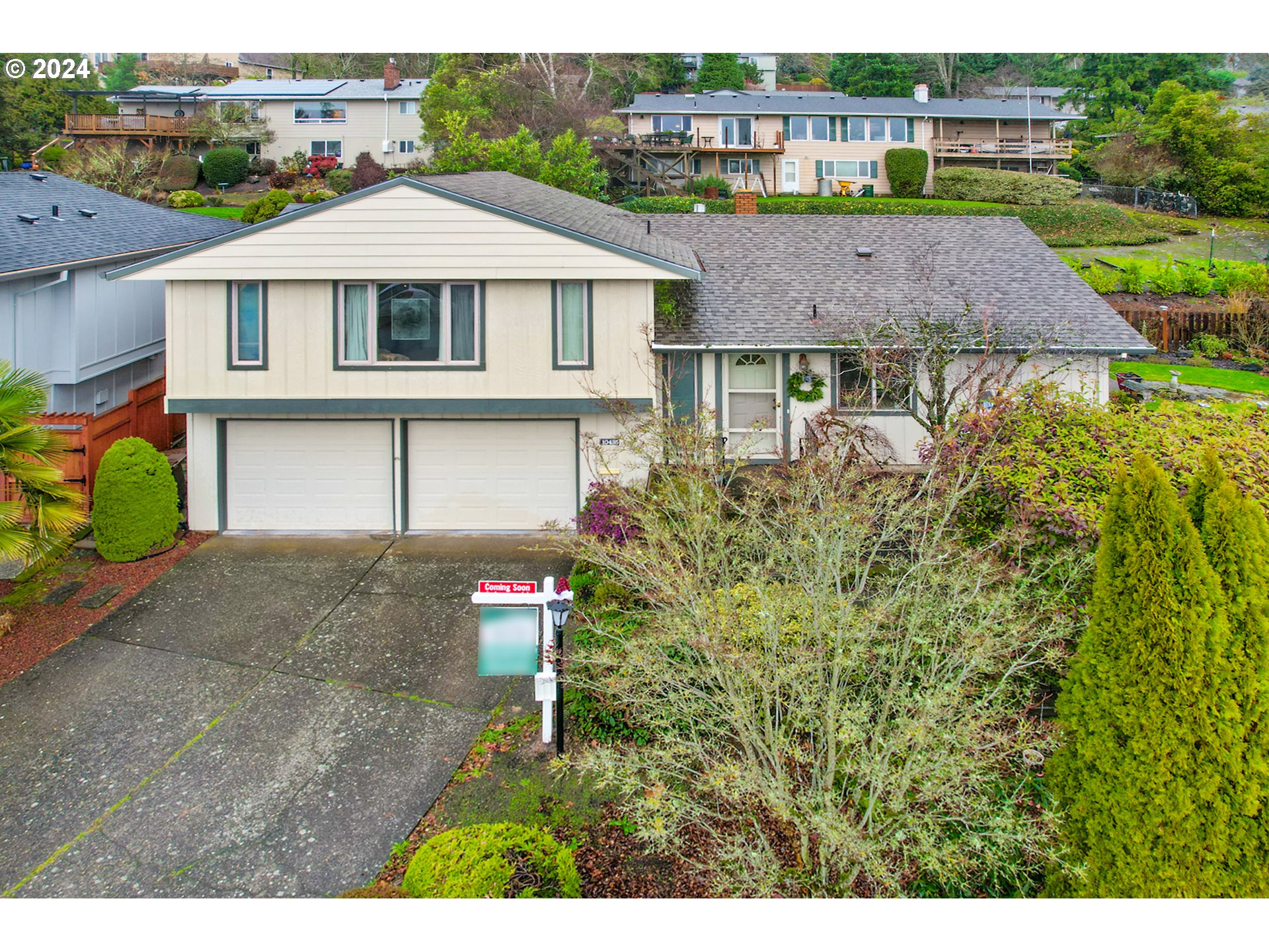 a aerial view of a house next to a yard