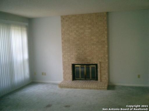 a view of an empty room with a fireplace