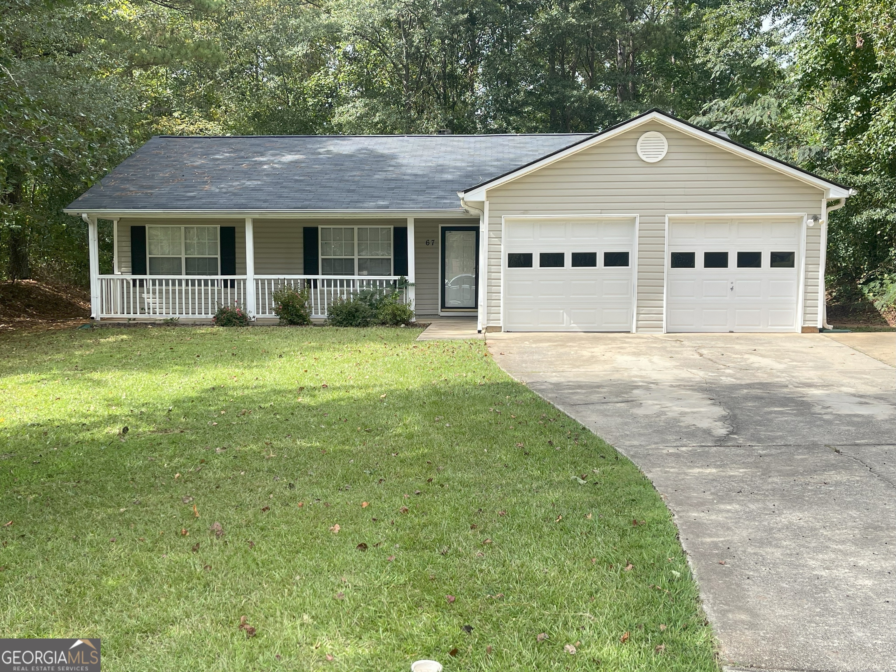 a front view of a house with a garden and porch