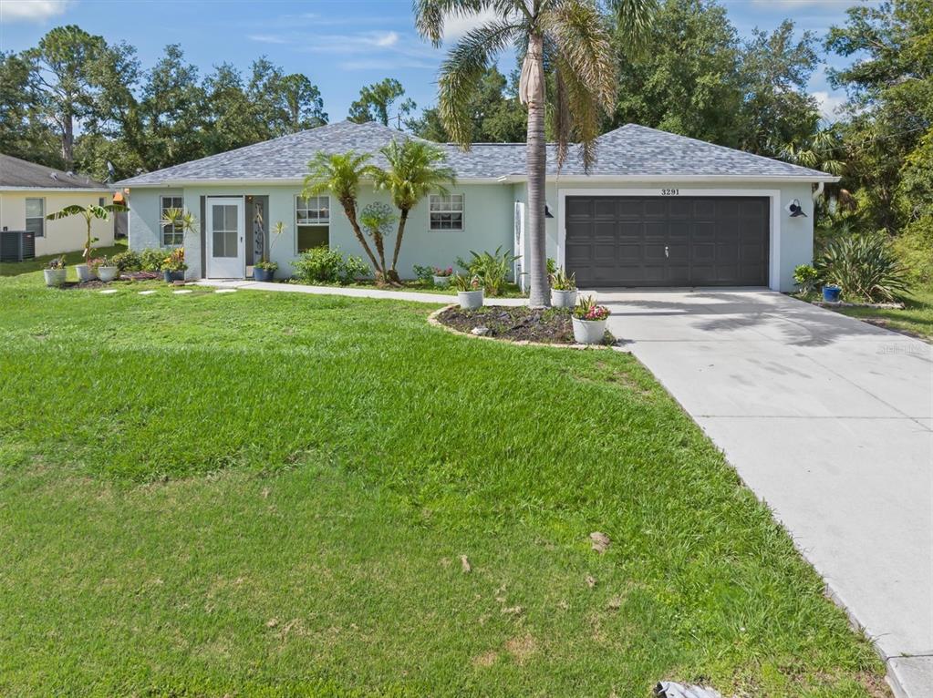 a front view of house with yard and green space