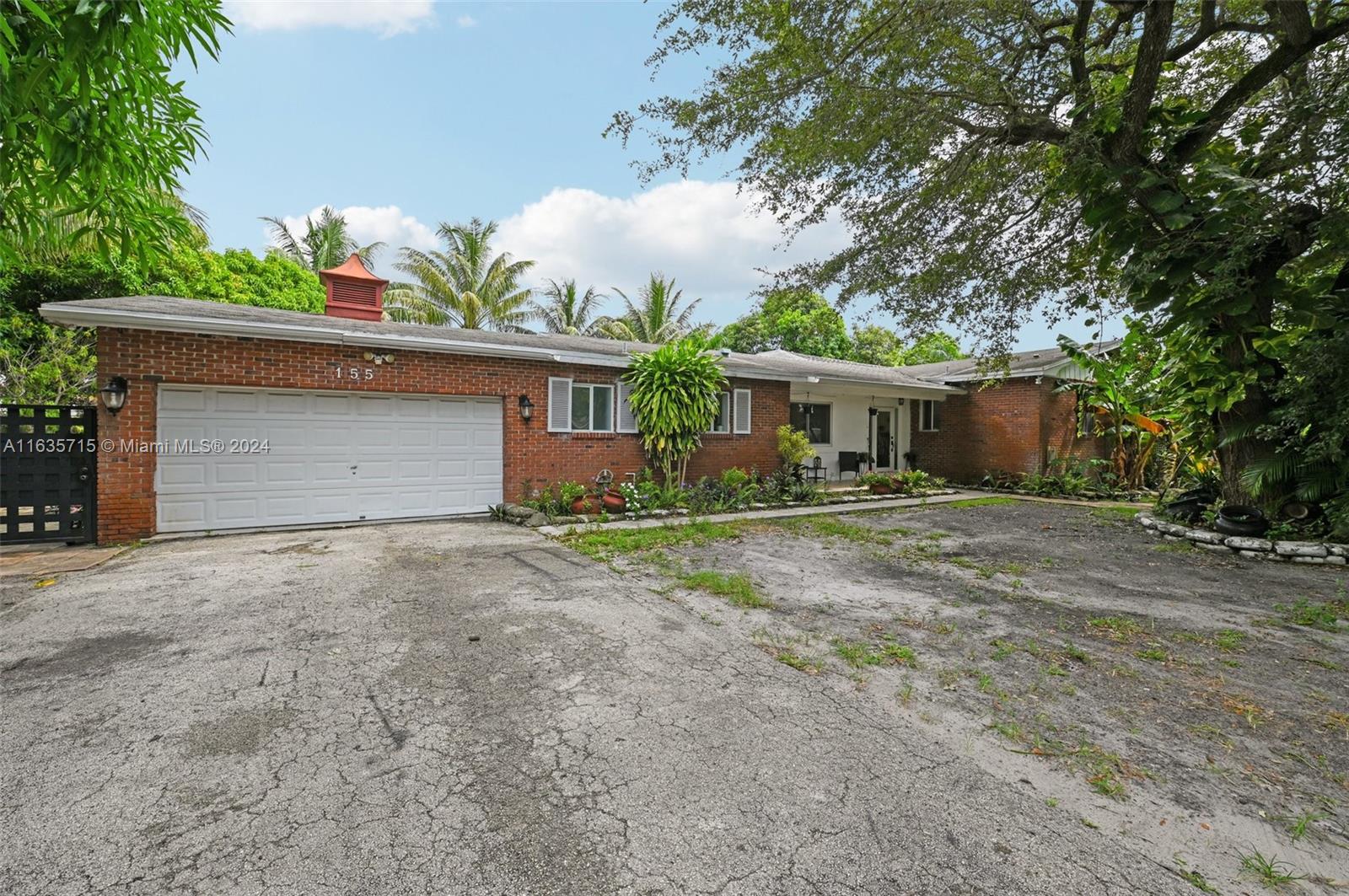 front view of a house with a yard and a garage