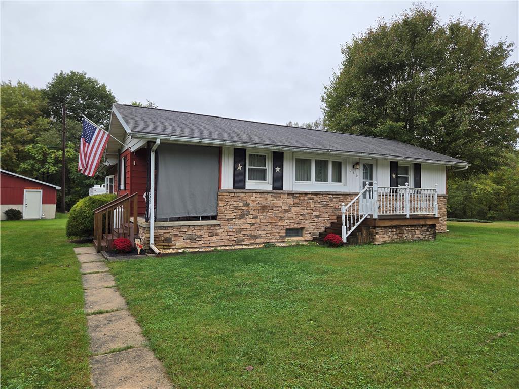 a view of a house with a yard and porch