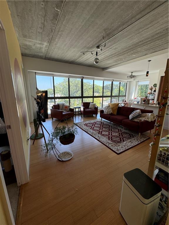 a living room with furniture a flat screen tv and a large window