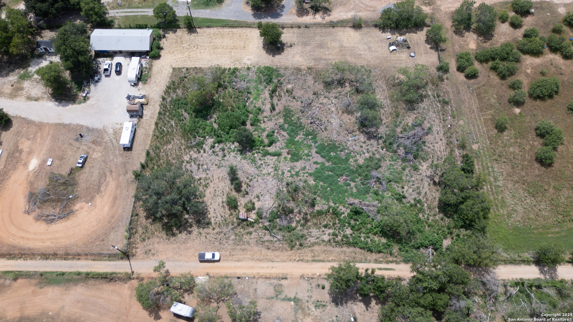 an aerial view of a house with outdoor space and street view