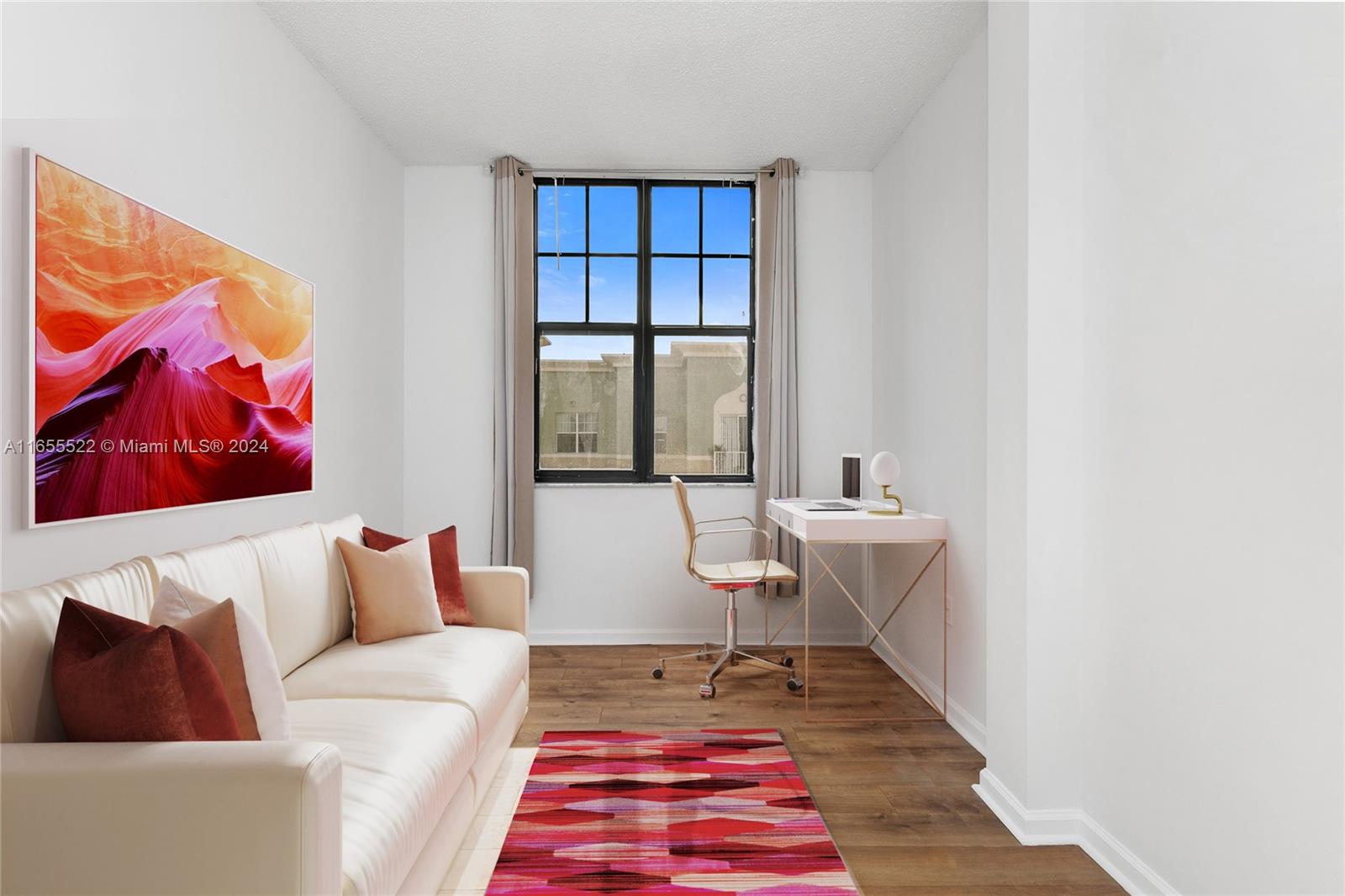 a living room with furniture and a rug