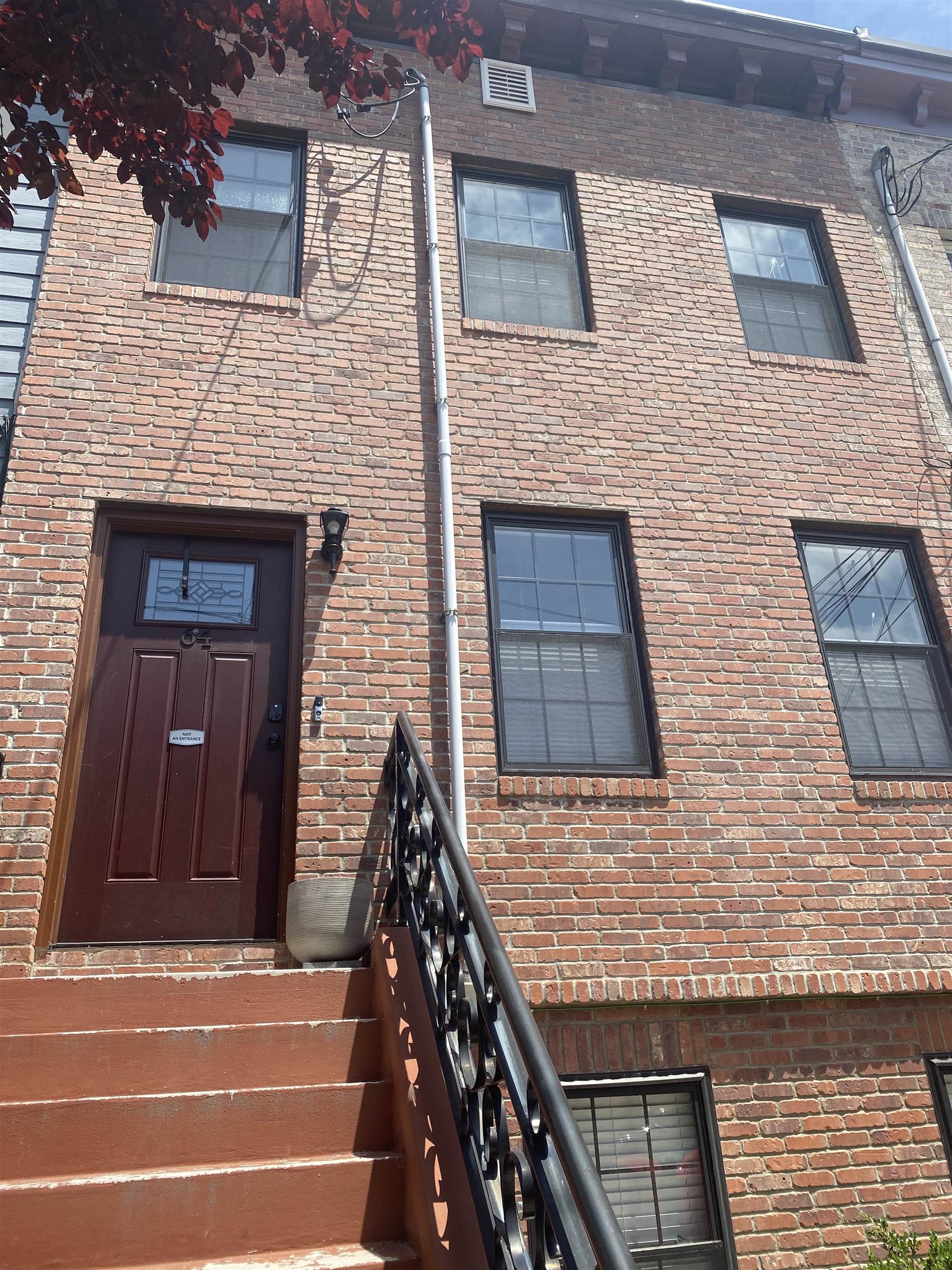 a view of brick house with a door