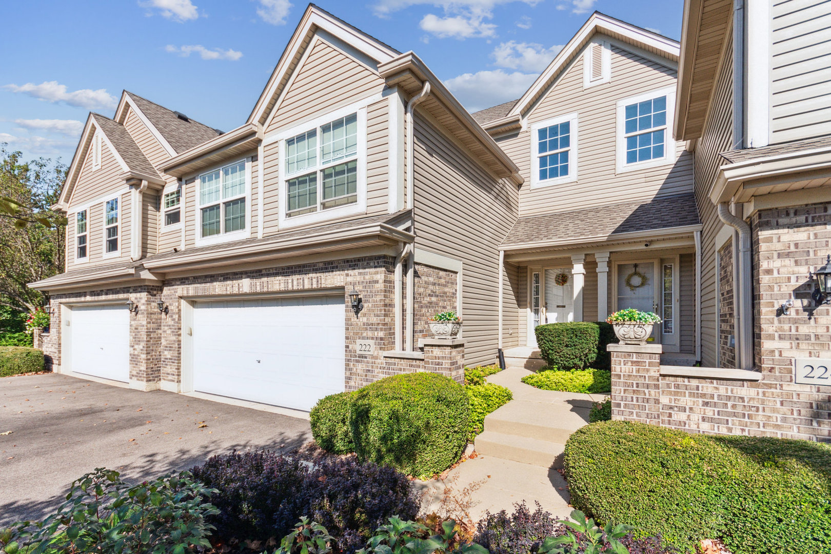 a front view of a house with a yard and outdoor seating