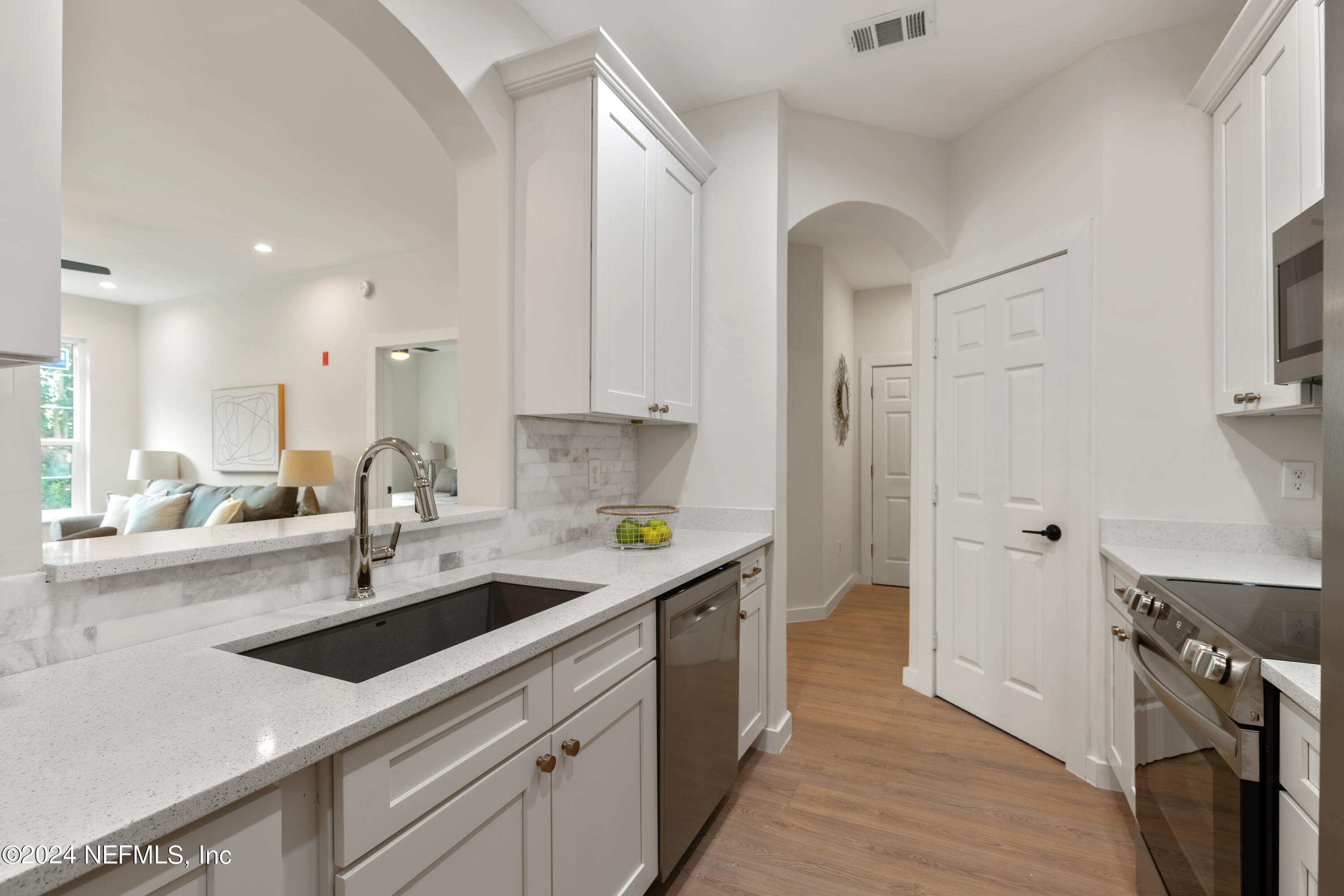 a kitchen with stainless steel appliances a sink a stove and a refrigerator