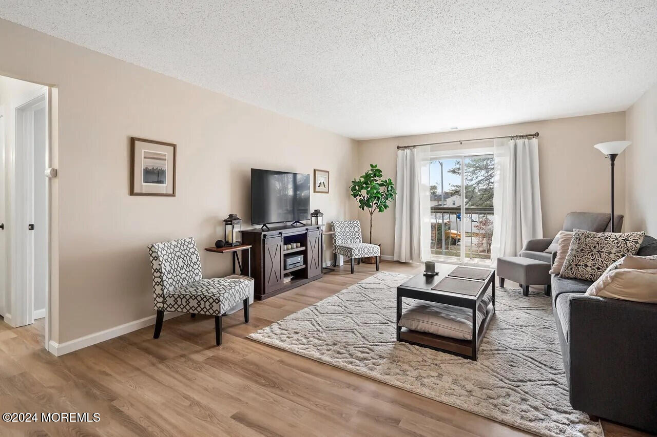 a living room with furniture rug and wooden floor