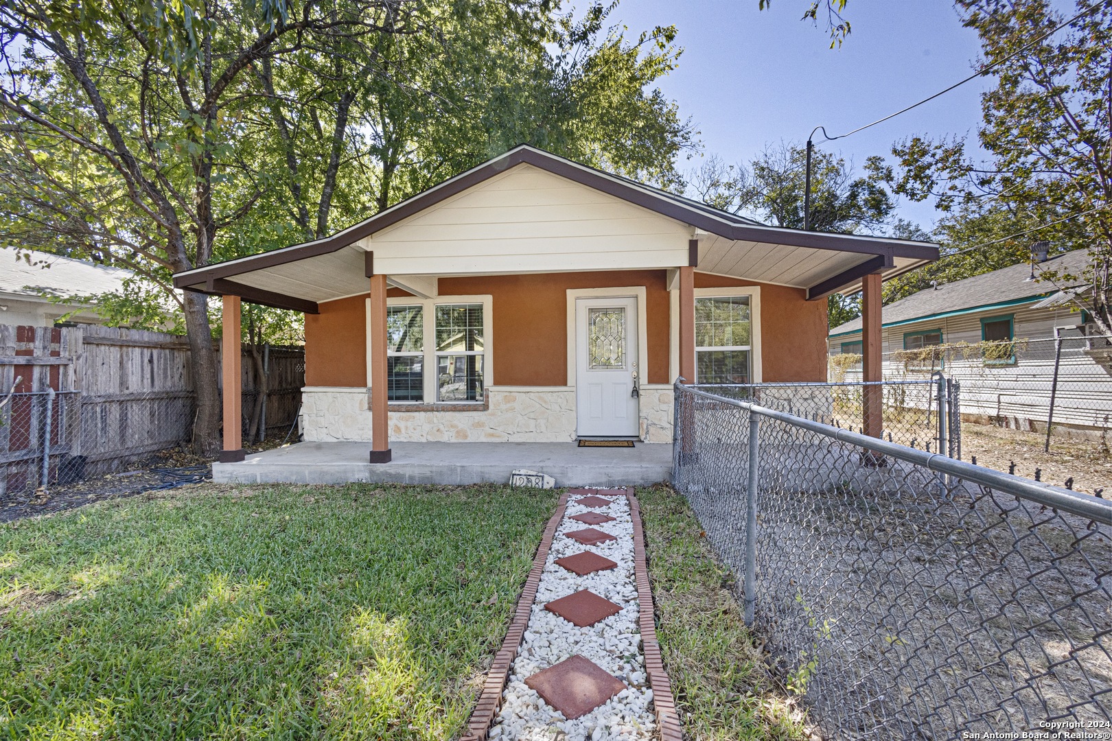 a front view of a house with a yard and outdoor seating