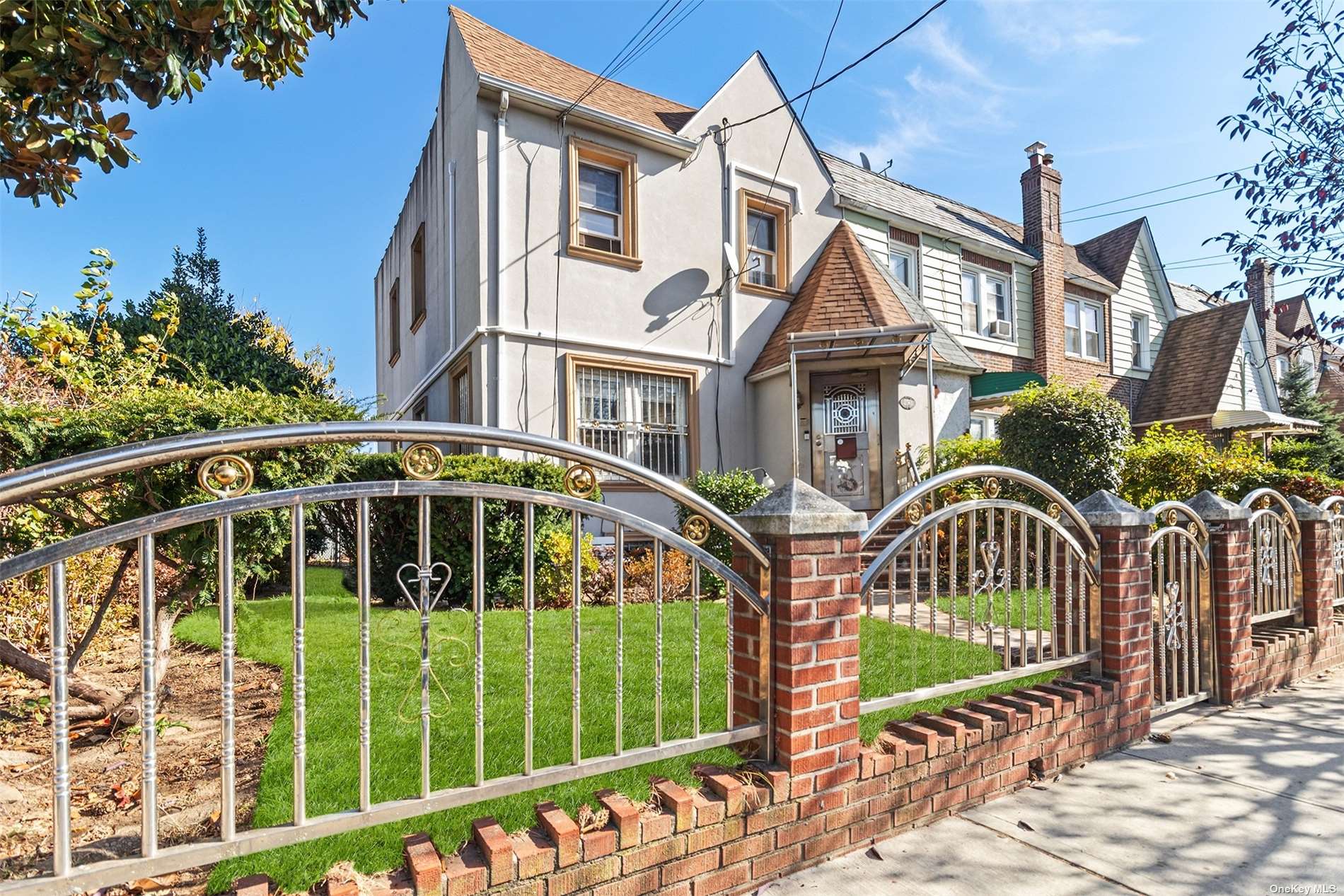 a front view of a house with a garden