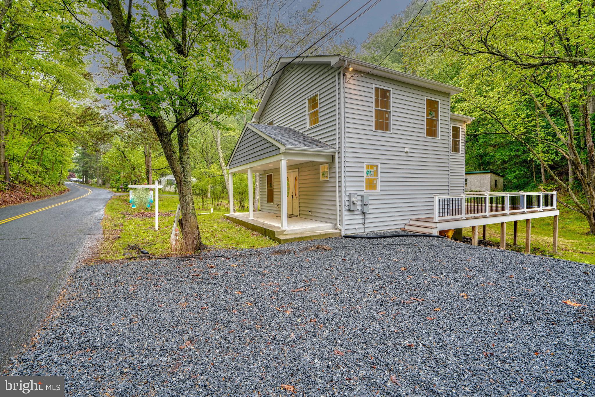 a view of a house with a backyard