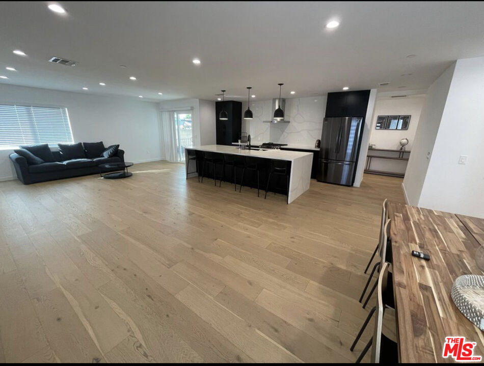 a kitchen with stainless steel appliances a refrigerator sink and cabinets