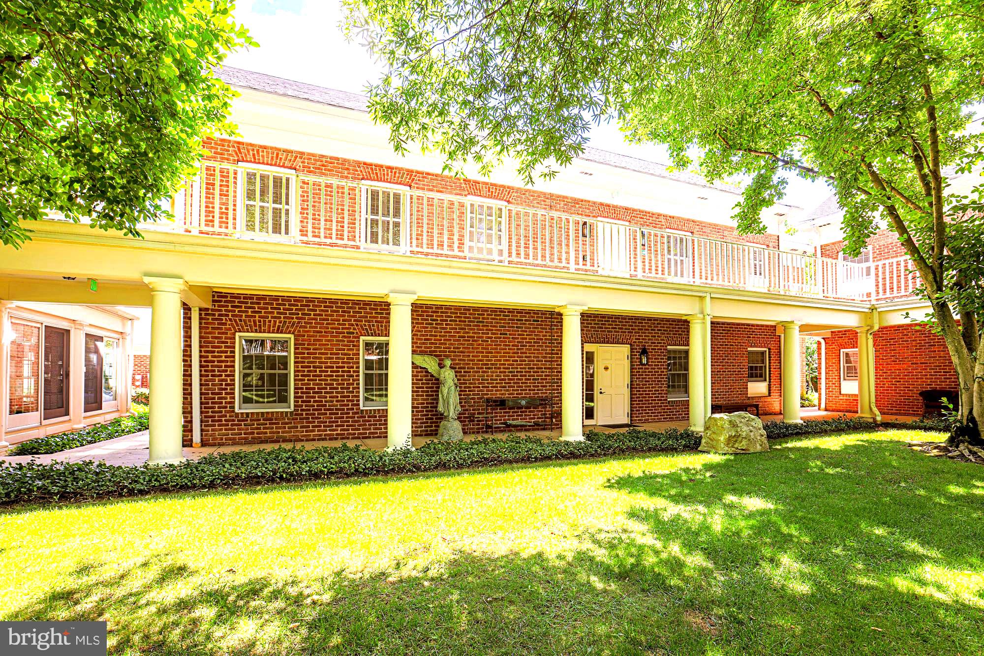 a front view of a house with a yard table and chairs