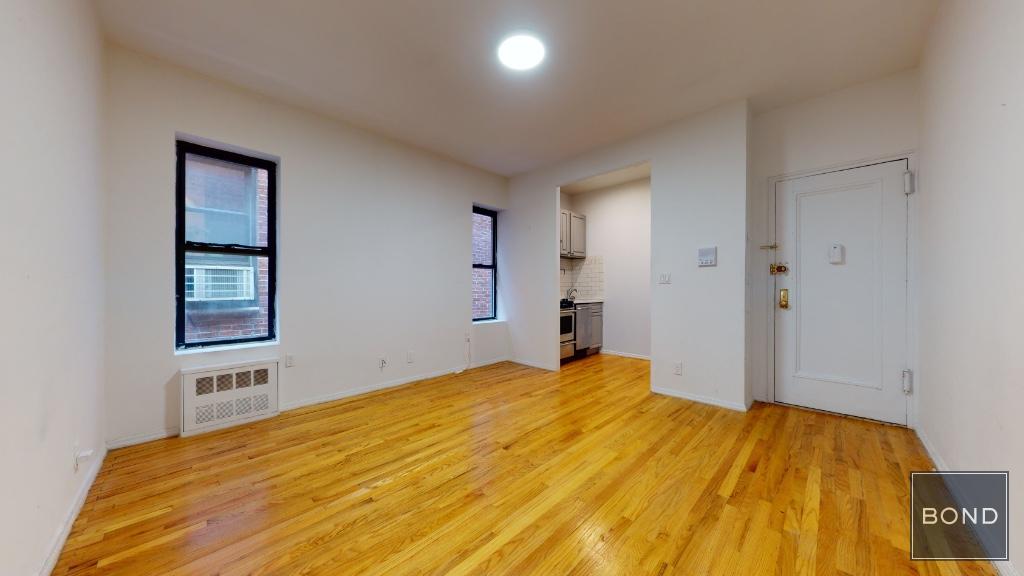 a bedroom with a bed and painting on the wall