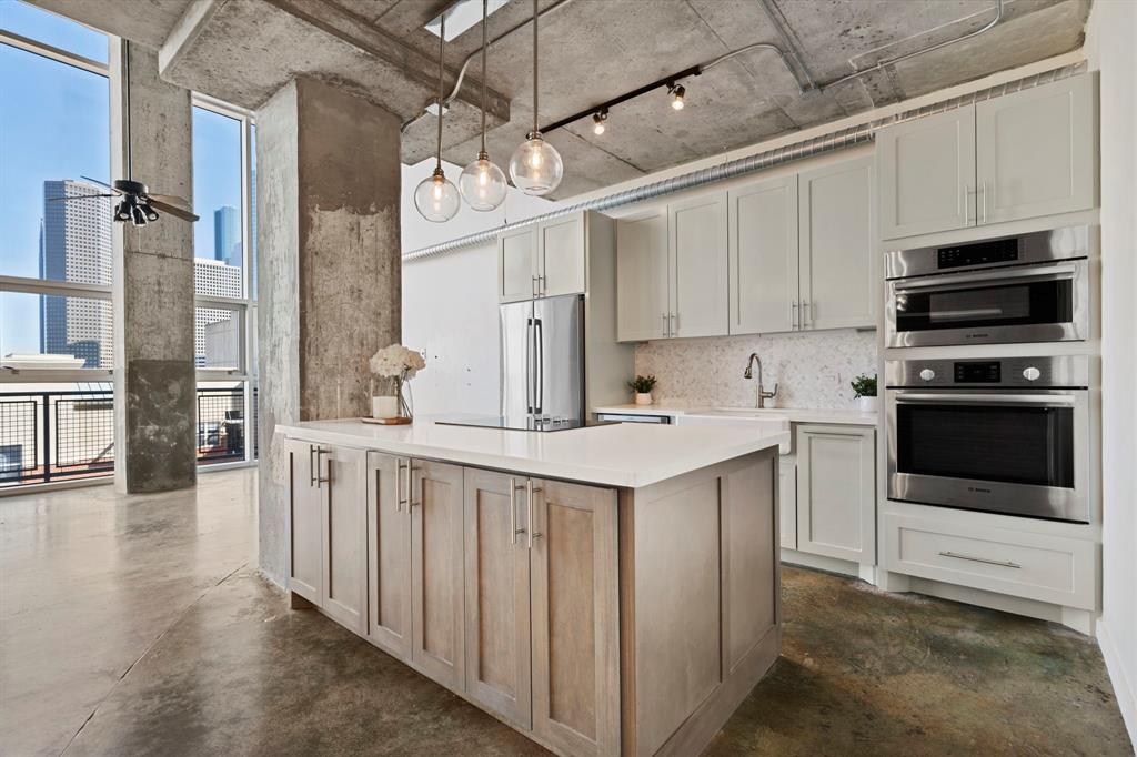 a kitchen that has a sink and a stove in it